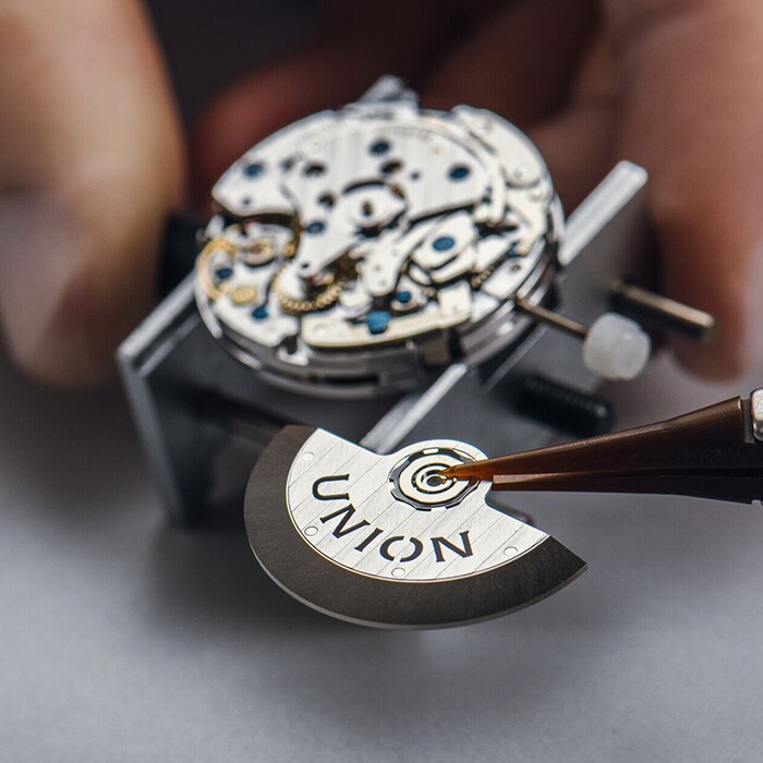 Rotor is inserted into a clockwork.
